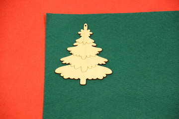 Fototapeta na wymiar Wooden christmas and new year tree on green and red background