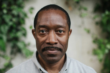 Serious but hopeful stare from a mature man.