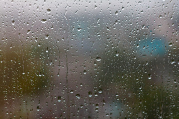 Glass rainy window texture. Raindrops on the window glass bokeh.  Condensation. Wet glass. Rain drops on the window.