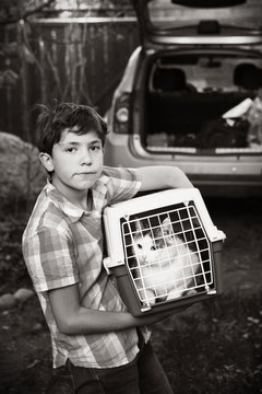 country boy with cat in carrier going to travel car