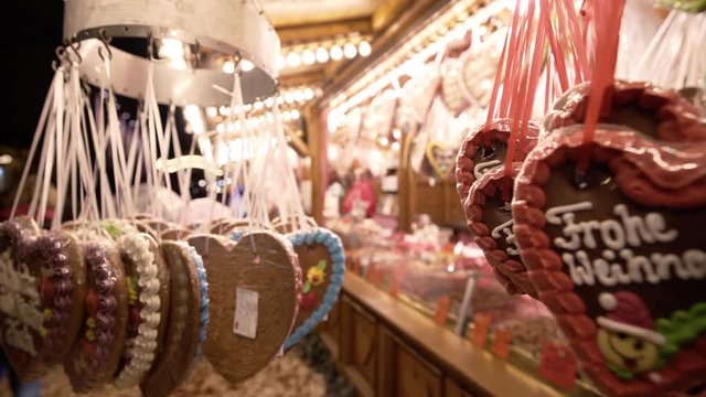 Gingerbread hearts hang in front of a sweets shop on a german Christmas market