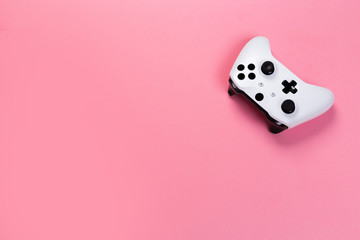 White joystick gamepad, game console on pink background. Computer gaming technology play competition videogame control confrontation concept. Cyberspace symbol