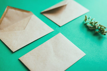 Envelopes with a white letter sheet on a green background.