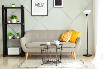 Stylish interior of room with comfortable sofa