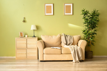 Stylish interior of room with comfortable sofa