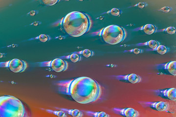 Macro shot of water bubbles on a colored surface. Abstract water bubbles texture. Flow concept. 
