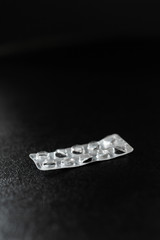 Empty blister from pills lies on the table