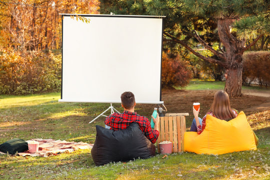 Young Couple Watching Movie In Outdoor Cinema