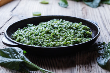 Vegan dish, spinach risotto in cast iron skillet