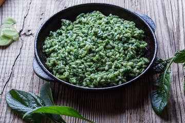 Vegan dish, spinach risotto in cast iron skillet