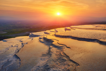 Beautiful sunrise and Natural travertine pools and terraces in Pamukkale.