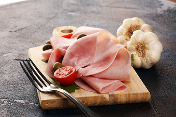 Sliced ham on wooden background. Fresh prosciutto cotto. Tasty Pork ham sliced