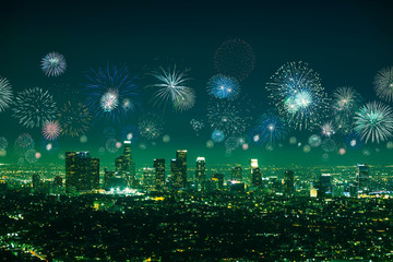 Downtown Los angeles cityscape with flashing fireworks celebrating New Year's Eve.
