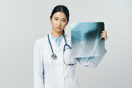 female doctor looking at xray