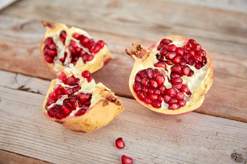 ripe organic pomegranate on teh wooden background