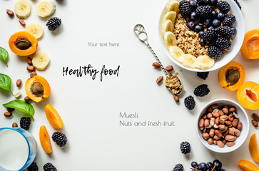 Creative layout of fresh summer fruits, muesli, nuts and grains on a white background with space for text.