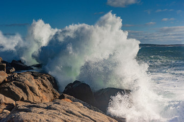 Waves breaking against rocks