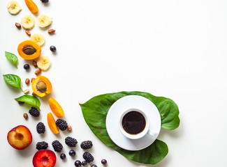 Creative layout of fresh summer fruits and coffee on a white background with space for text.