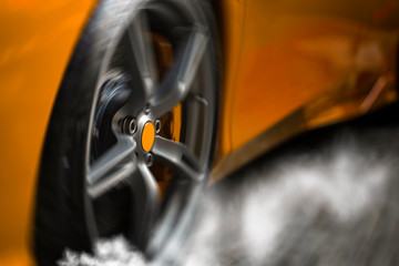 Detail on hot red super-sport car wheels with sport breaks