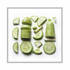 Sliced ​​zucchini, laid out in a square form. Background with fresh zucchini on a white background in a square. Seamless pattern. Vegetables isolated. View from above