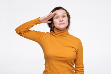 Caucasian young woman in yellow clothes is ready to do her best at work.