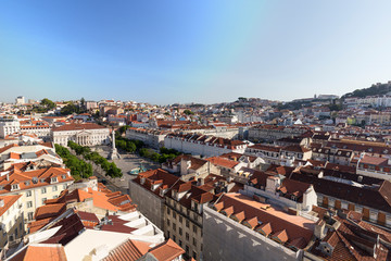 View of the Rossio Square (Praca do Rossio), historical Baixa and Alfama districts and beyond from above in Lisbon, Portugal, on a sunny day.