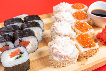 Set of rolls with salmon, red caviar, and flying fish. With krill. Close-up