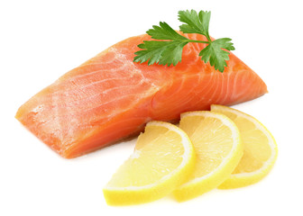 Red fish. Raw salmon fillet with parsley and lemon isolate on white background