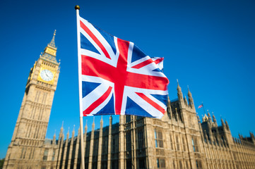 Single Union Jack flag waving in front of Big Ben at the Houses of Parliament in London, UK on a...
