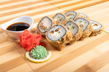 Baked roll breaded. with various fillings. With ginger and wasabi. Close-up