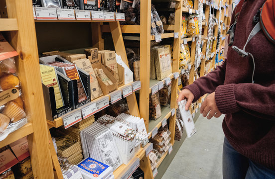 Barcelona, Spain - Nov 17, 2017: Woman choosing organic traditional Catalan black and milk chocolate in a sweets section of organic local food store