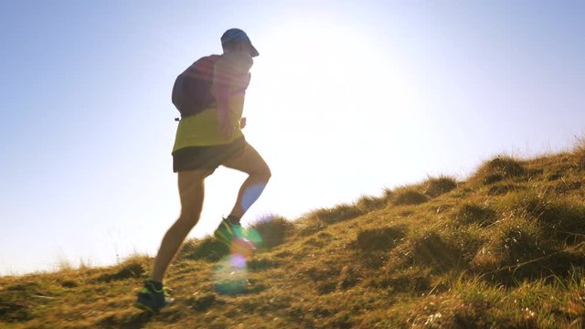 A man jogging up the hill in slow motion