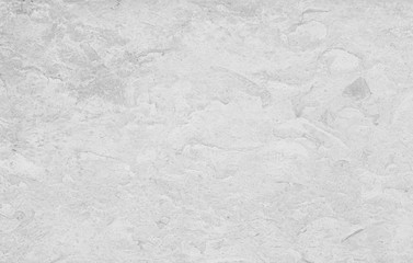 Close-up of a pale stone wall or slab in black and white. High resolution abstract full frame textured background.