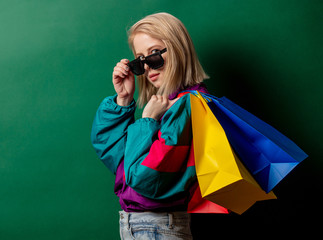Style woman in 90s punk clothes with shopping bags