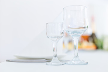 empty wineglasses and a plate on the table. wedding reception. c
