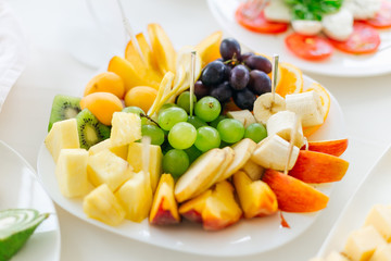 closeup of a plate with a large assortment of fruits. celebratin