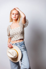 Style blond woman in denim jeands and polka dot blouse