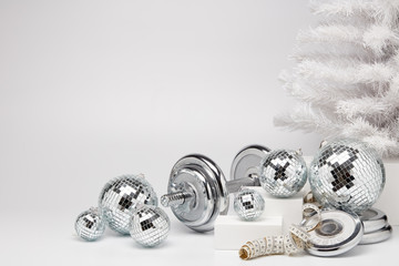 Dumbbell and Christmas ornaments. Fitness New Year and Christmas background