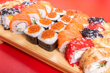 Sushi set of rolls and poppies, with salmon and caviar. With tuna and krill California and Philadelphia. Close-up.