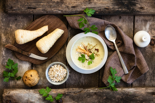 Directly above shot of oats soup served with ingredients on wooden table