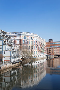Buildings by White Elster against clear blue sky during sunny day in Saxony, Germany