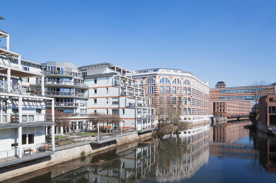 Buildings by White Elster against clear blue sky during sunny day in Saxony, Germany