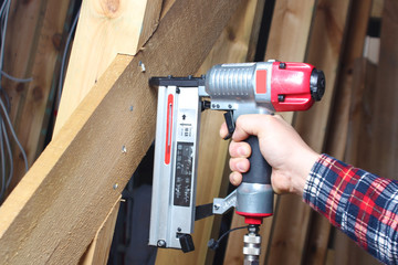 pneumatic stapler red hand wooden worker