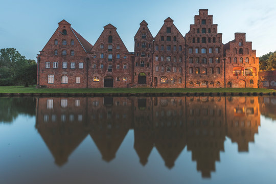 Salzspeicher reflecting on Trave River against sky at dusk in L?beck, Germany