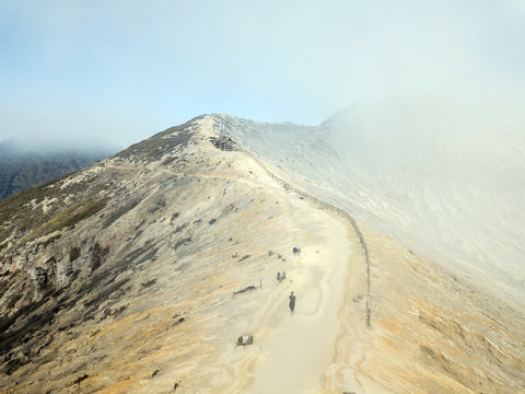 Indonesia, Java, Person walking toward secluded hut overlooking?Ijen?volcano