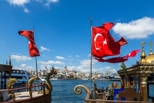 Turkish flags on boats against sky, Bosphorus, Istanbul, Turkey