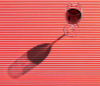 High angle view of red wine served on striped table