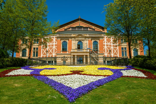 Colorful flowers in front of Bayreuth Festspielhaus during sunny day, Bayreuth, Germany