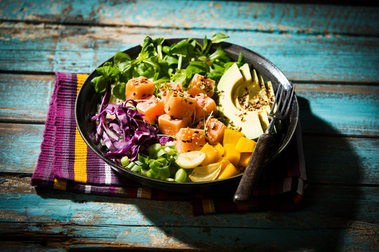 Close-up of poke bowl with fork on table - Powered by Adobe