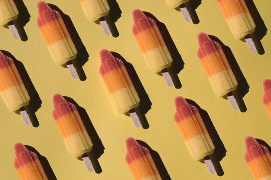 Directly above shot of sorbets arranged on yellow background
